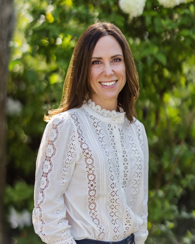 Shana Evans-Bassett, LPC, outdoors in a cream lace blouse